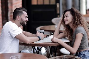 Portrait of a couple sitting down at a cafe while on vacation